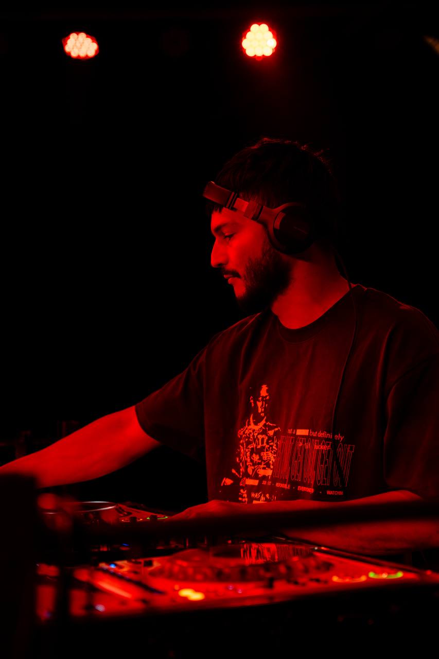 DJ with beard working the mixer